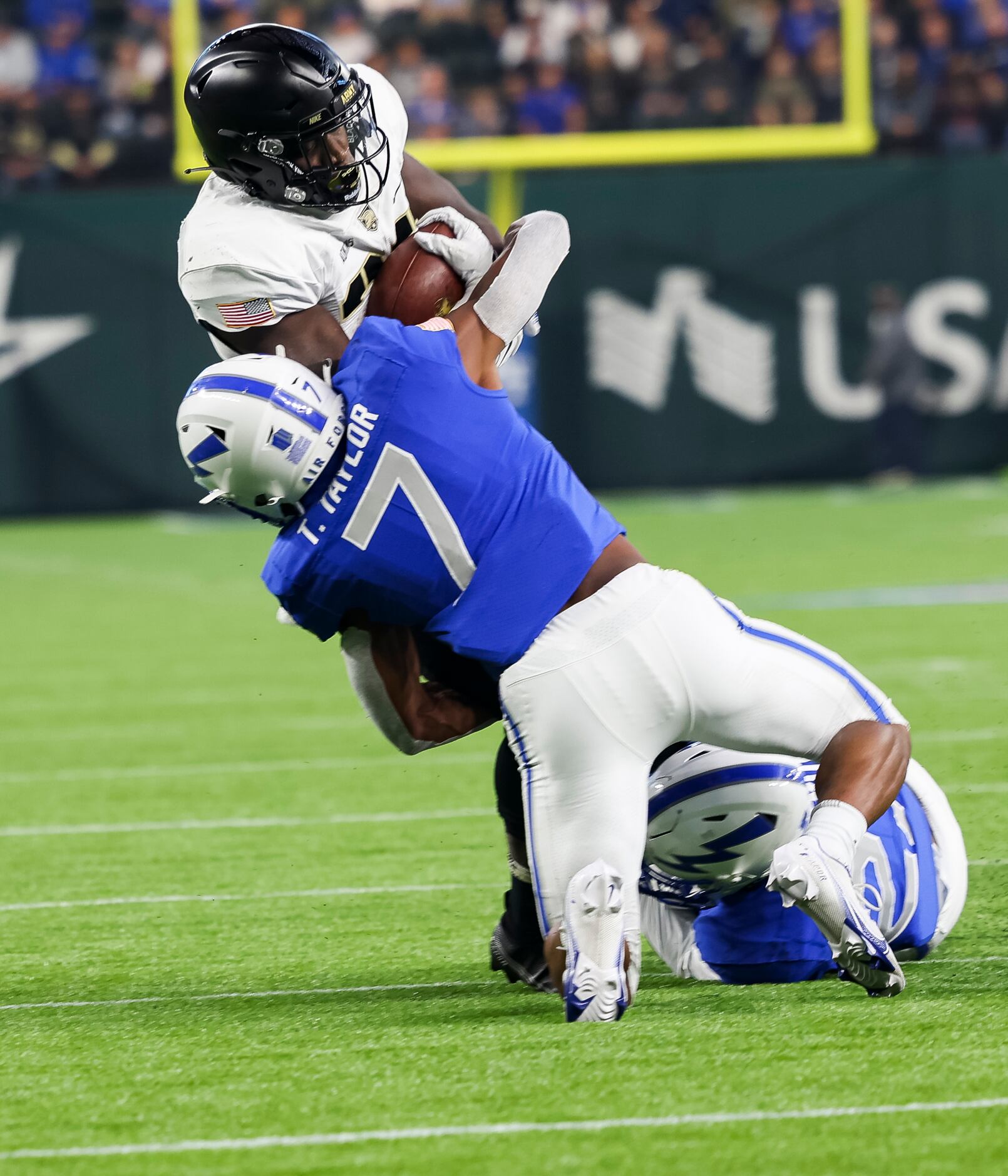 Army Black Knights running back Anthony Adkins (23) is tackled by Air Force Falcons safety...