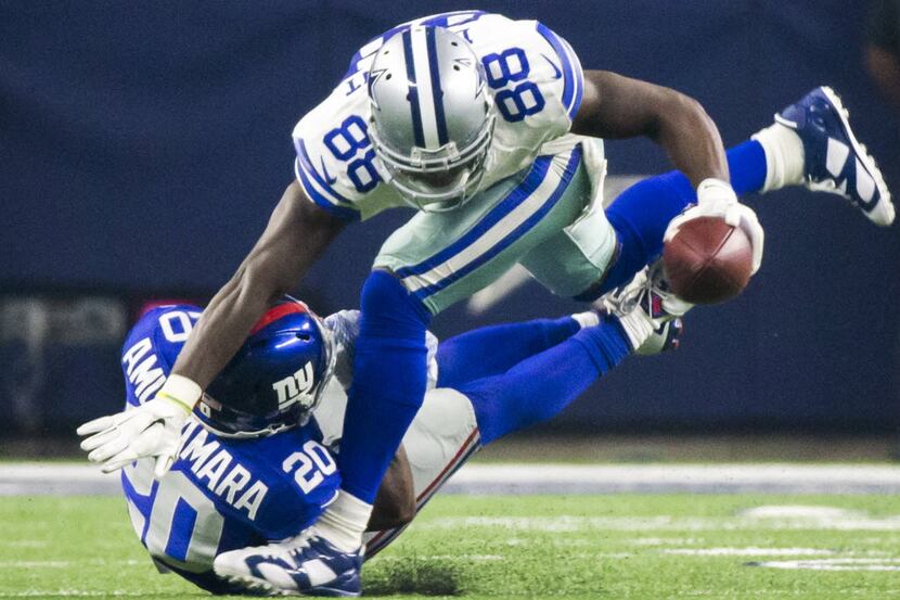 Dallas Cowboys wide receiver Dez Bryant (88) is brought down by New York Giants cornerback...