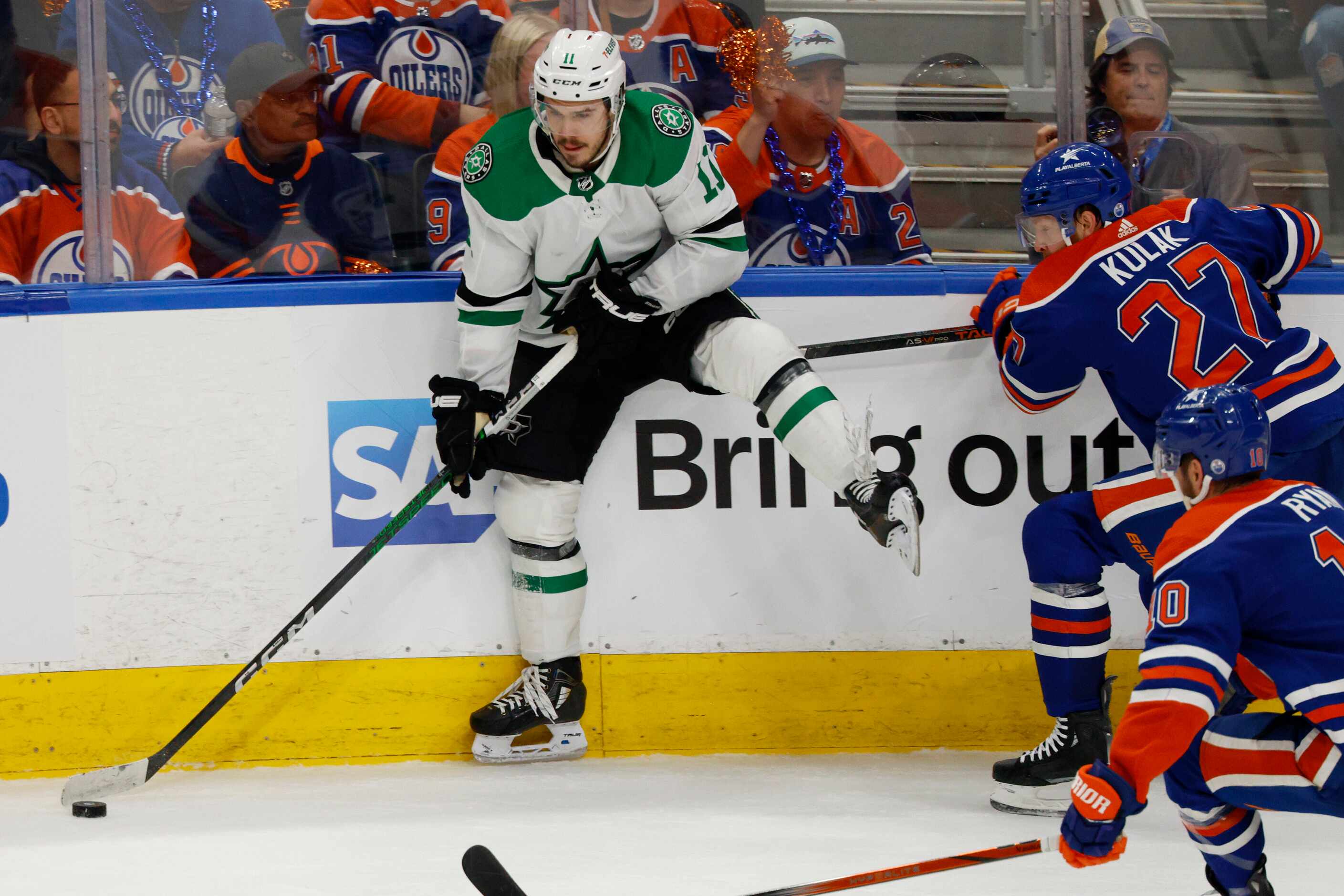 Dallas Stars center Logan Stankoven (11) handles the puck after a hit from Edmonton Oilers...