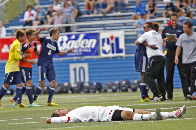 Coppell player Austin Michaelis (25) lies on the ground after his team was defeated by Fort...