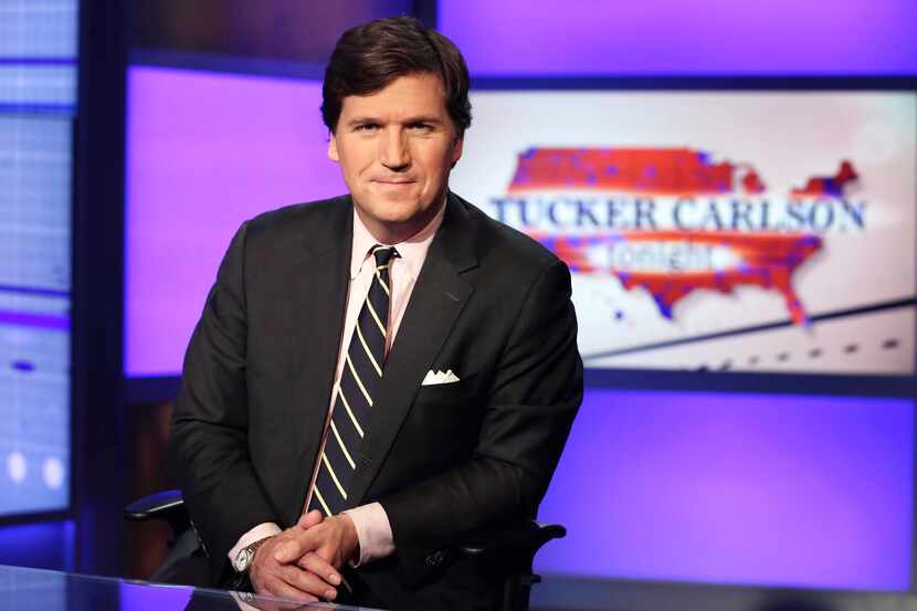 FILE - Tucker Carlson, host of "Tucker Carlson Tonight," poses for photos in a Fox News...