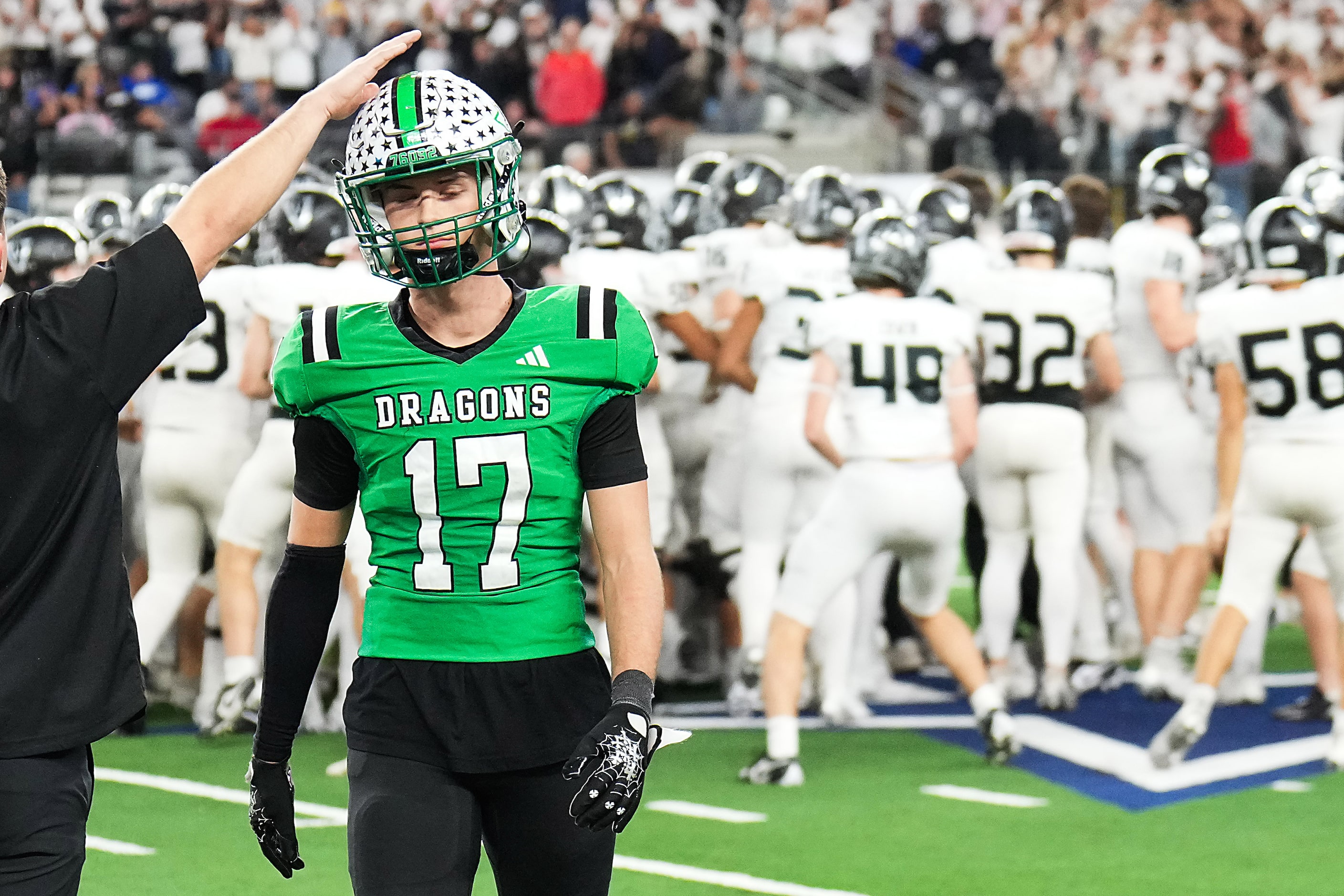 Southlake Carroll defensive back Ethan Fisher (17) gets a pat on the helmet as he leaves the...