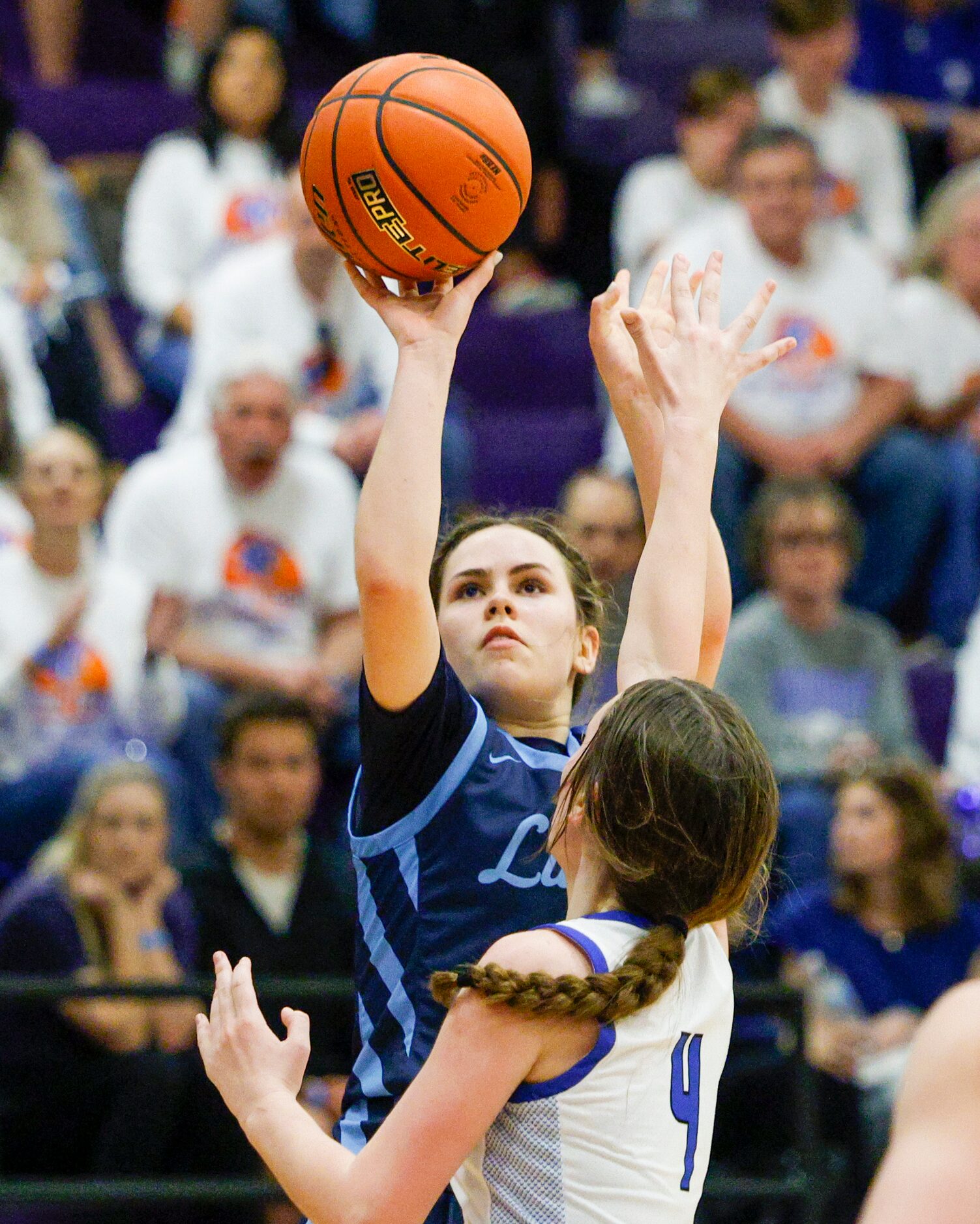 Argyle Liberty Christian guard Emma Martin (15) shoots over Tyler Grace Community forward...