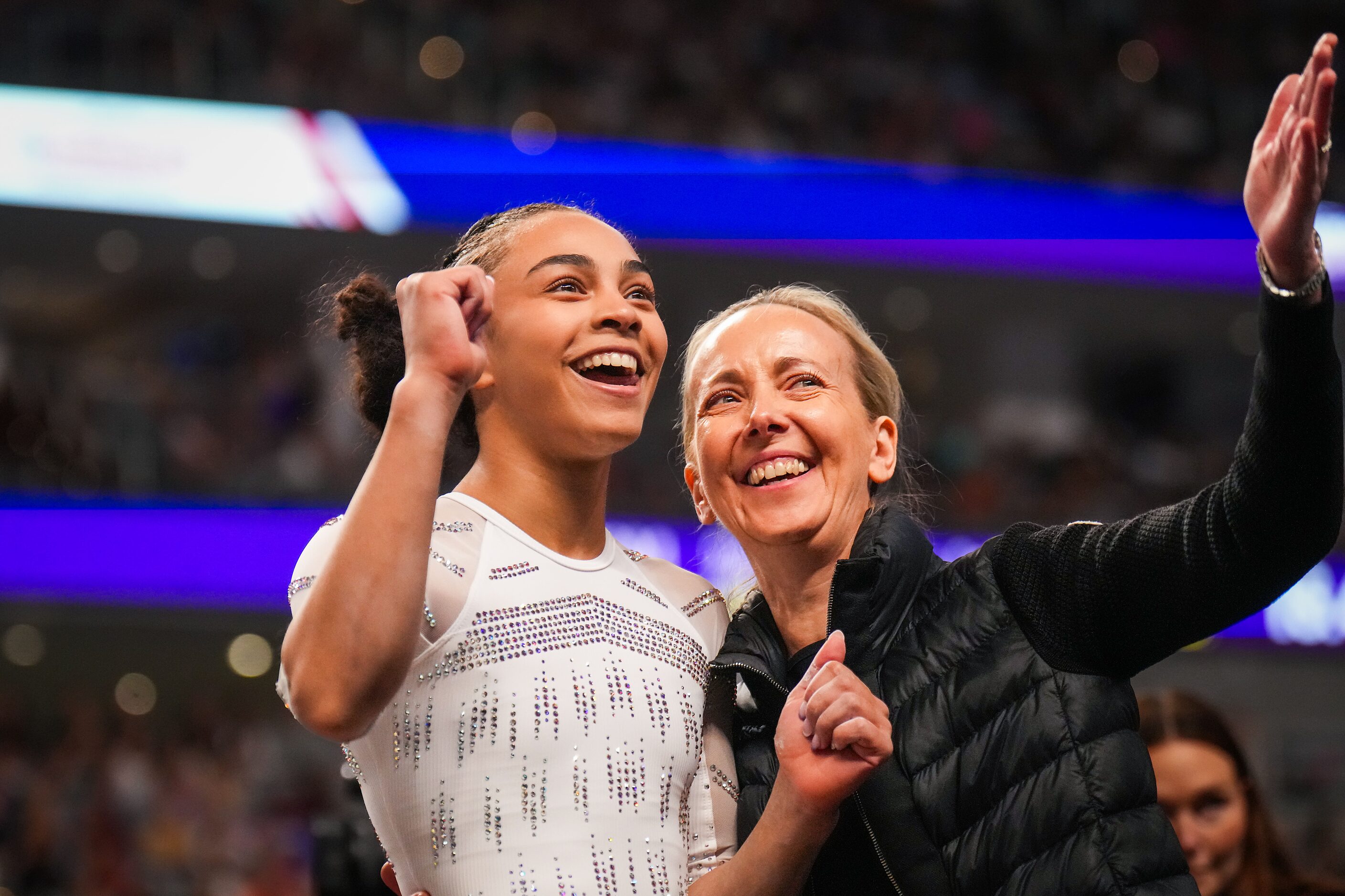 Hezly Rivera celebrates with coach Anna Kotchneva after she competed on the balance beam...