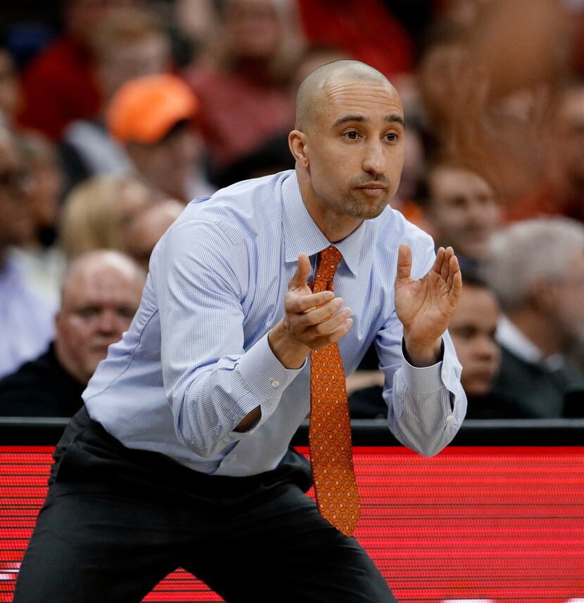 Texas coach Shaka Smart cheers on his team during the first half of an NCAA college...