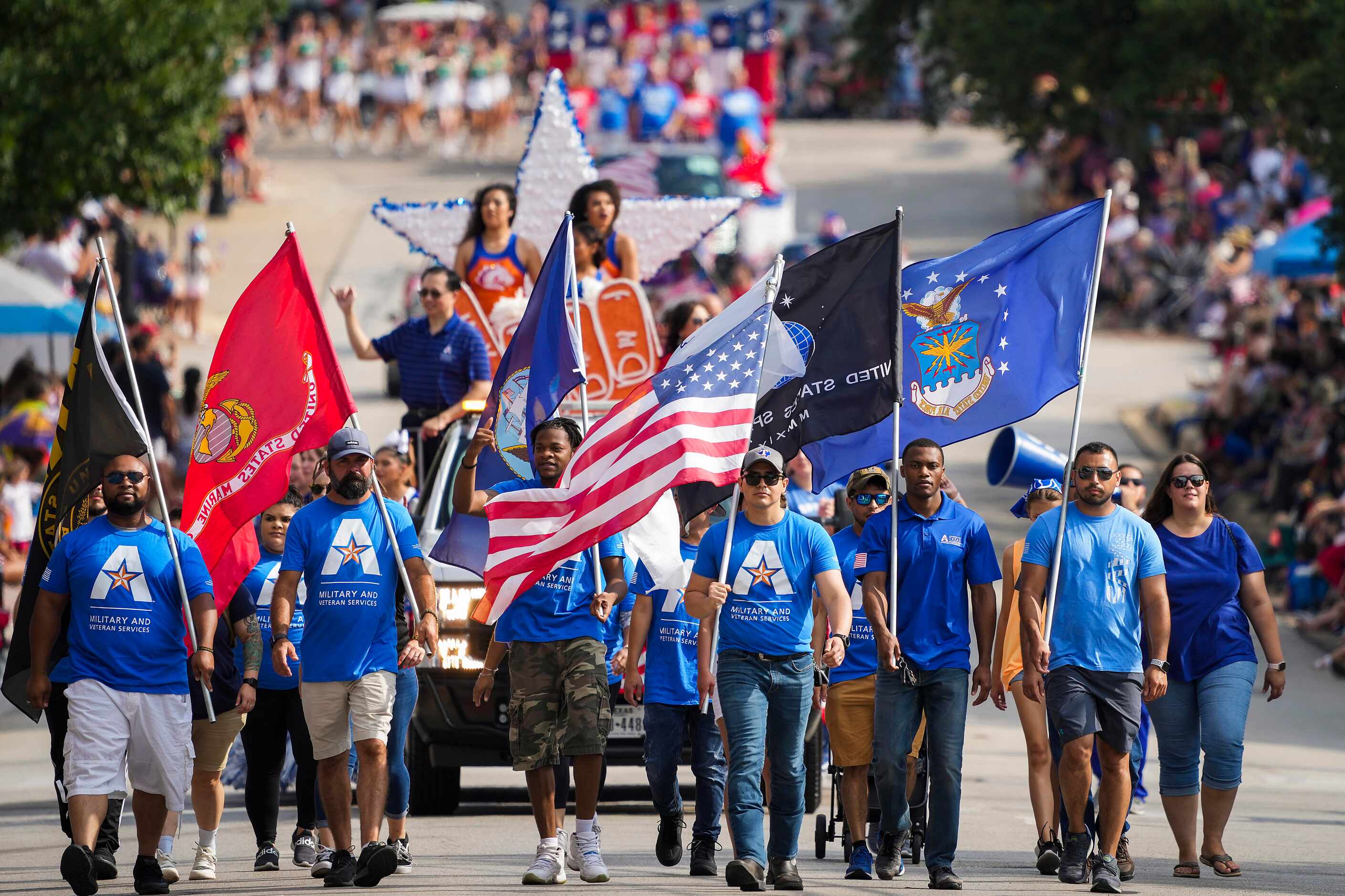 Representatives of UTA Military and Veterans Services carry the colors as they lead the...