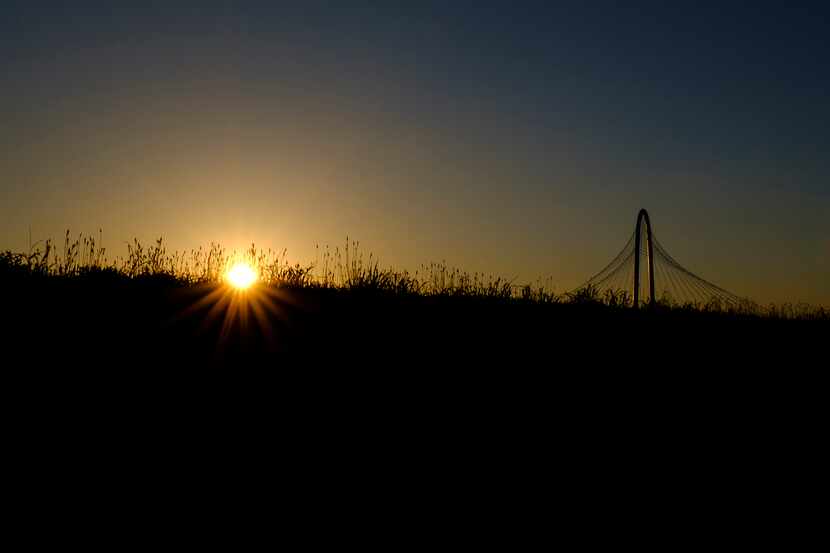 The sun setting behind the Margaret Hunt Hill Bridge on Wednesday, May 15, 2019, in Dallas. 