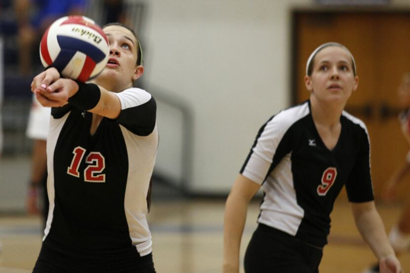 Colleyville Heritage's Anna Walsh (12) hits a ball as Chandler Templin (9) watches on during...