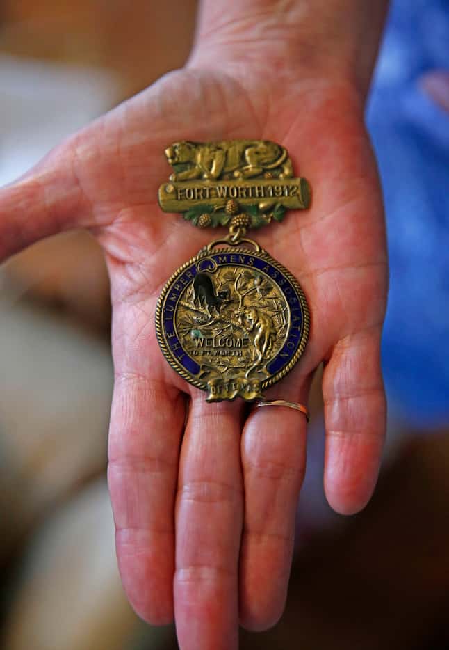 Tarrant County historian Carol Roark shows a Lumbermen's Association badge from 1912 at...