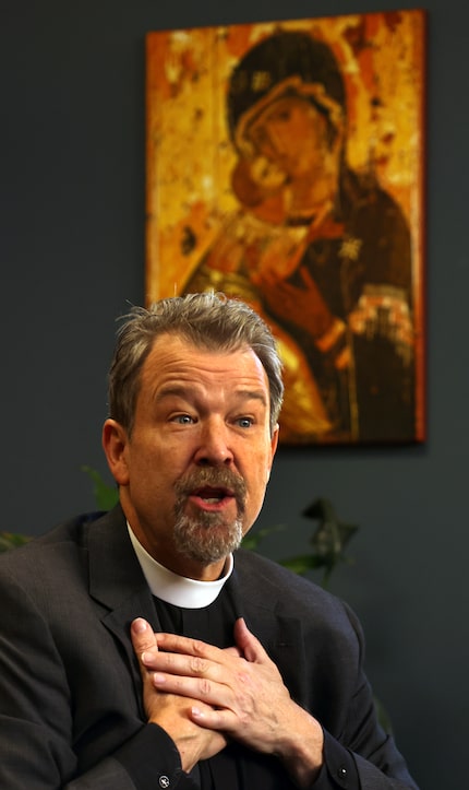 Father David Houk speaks in his St. John's office about the efforts of Leah Stuekerjuergen...