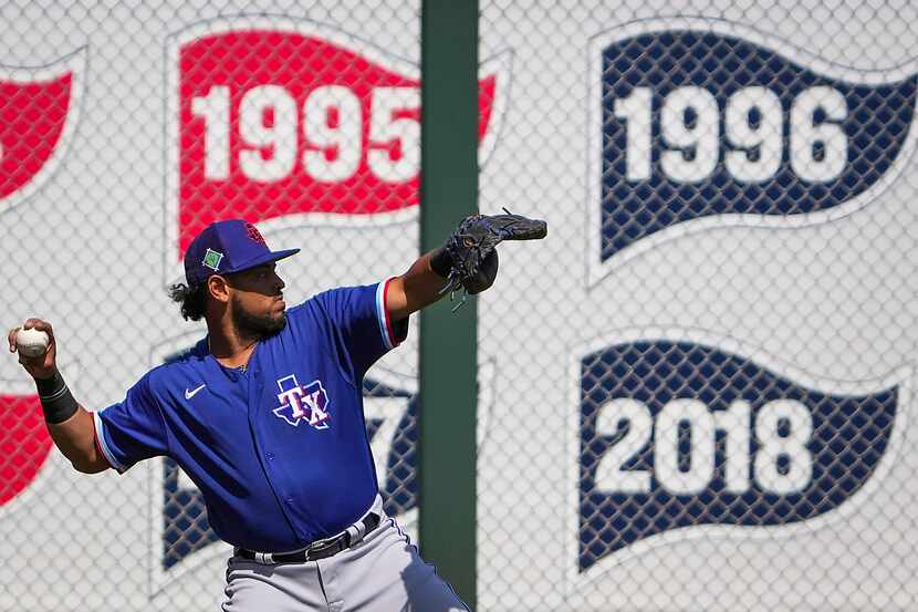 Texas Rangers catcher Meibrys Viloria warms up before a spring training game against the...