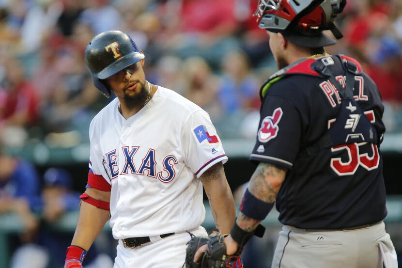 Texas Rangers second baseman Rougned Odor (12) chats with Cleveland Indians catcher Roberto...