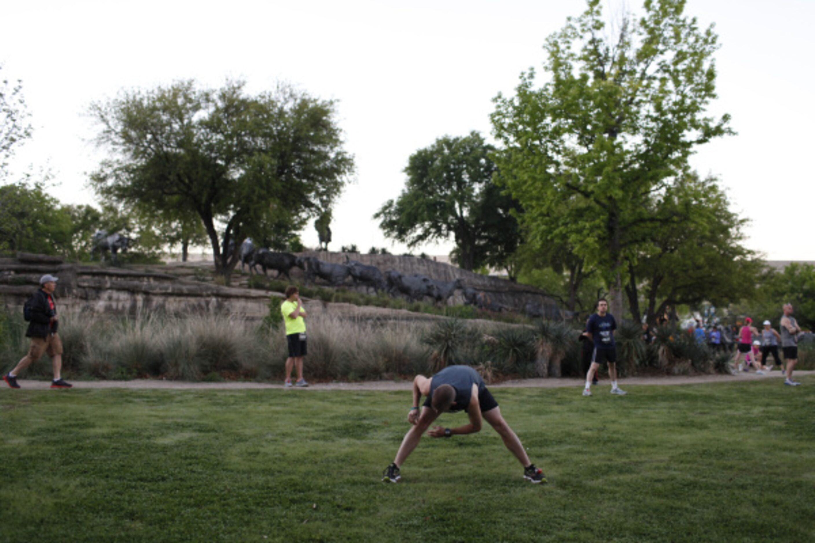 Participants of the Dallas Rock 'N' Roll half marathon stretch before the race begins on...