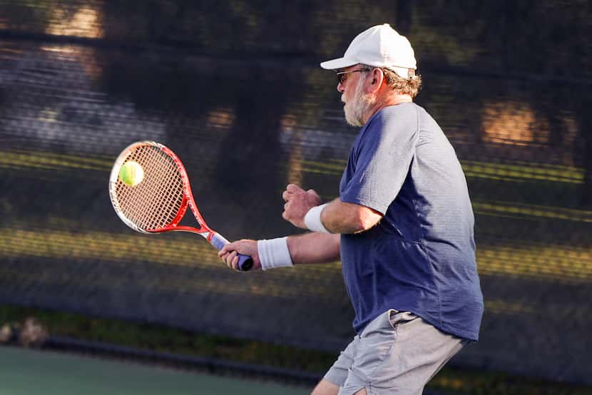Jim Duthie hits a tennis ball during doubles play at Cole Park June 8. 