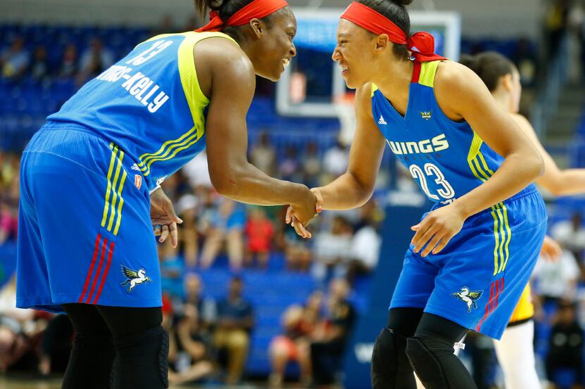Dallas Wings guard Karima Christmas-Kelly (13) welcomes forward Aerial Powers (23) to the...