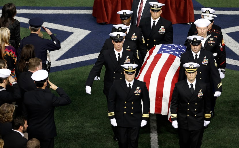 Taya Kyle, top left, wife of former Navy Seal Chris Kyle watch as the honor guard carries...