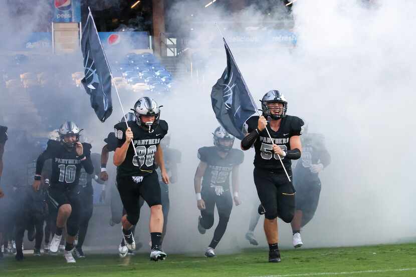 The Panther Creek Panthers enter the field to play the Emerson Mavericks on Friday, Sept. 9,...