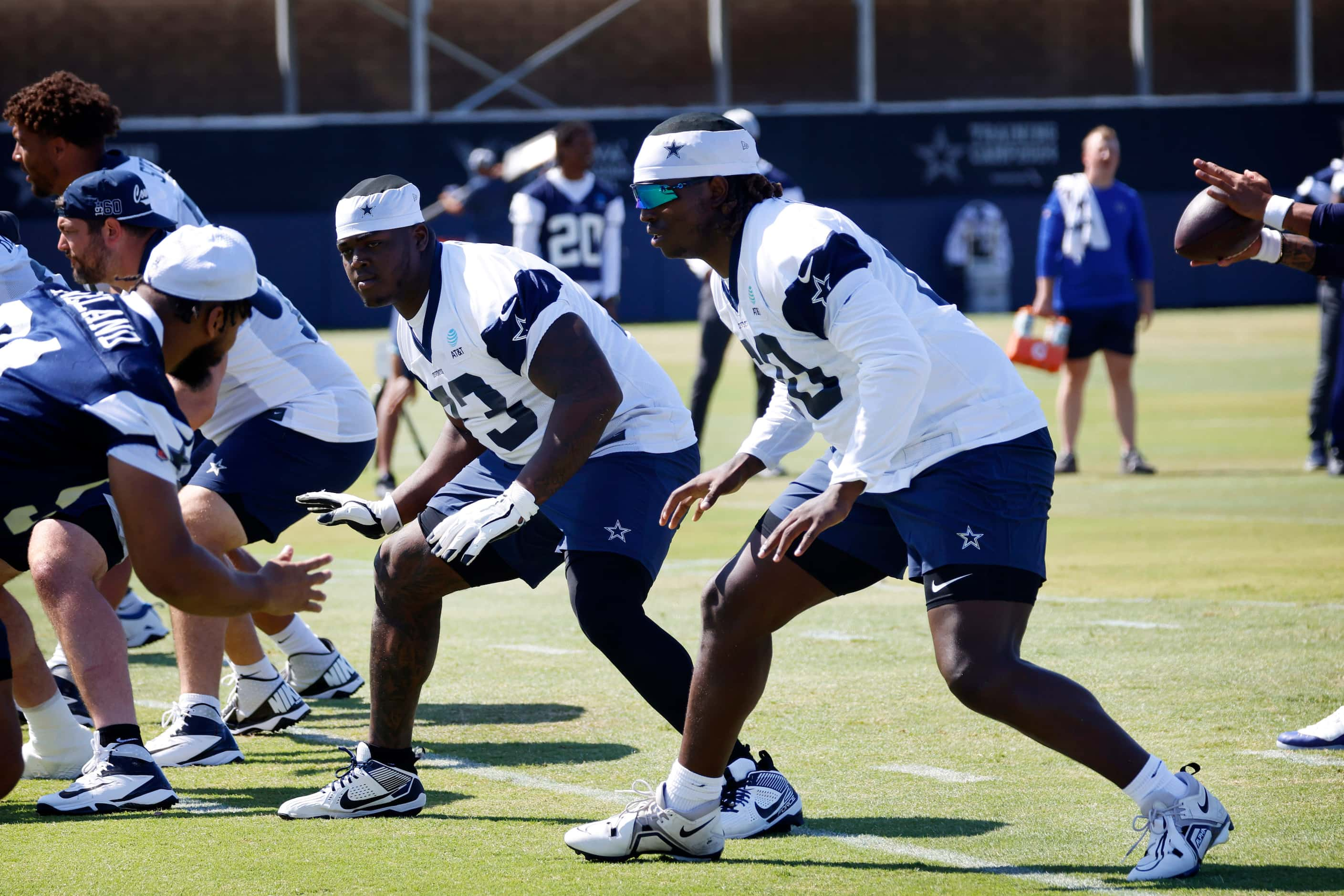 Dallas Cowboys offensive lineman Tyler Guyton (60) and Tyler Smith (73) step back as the...