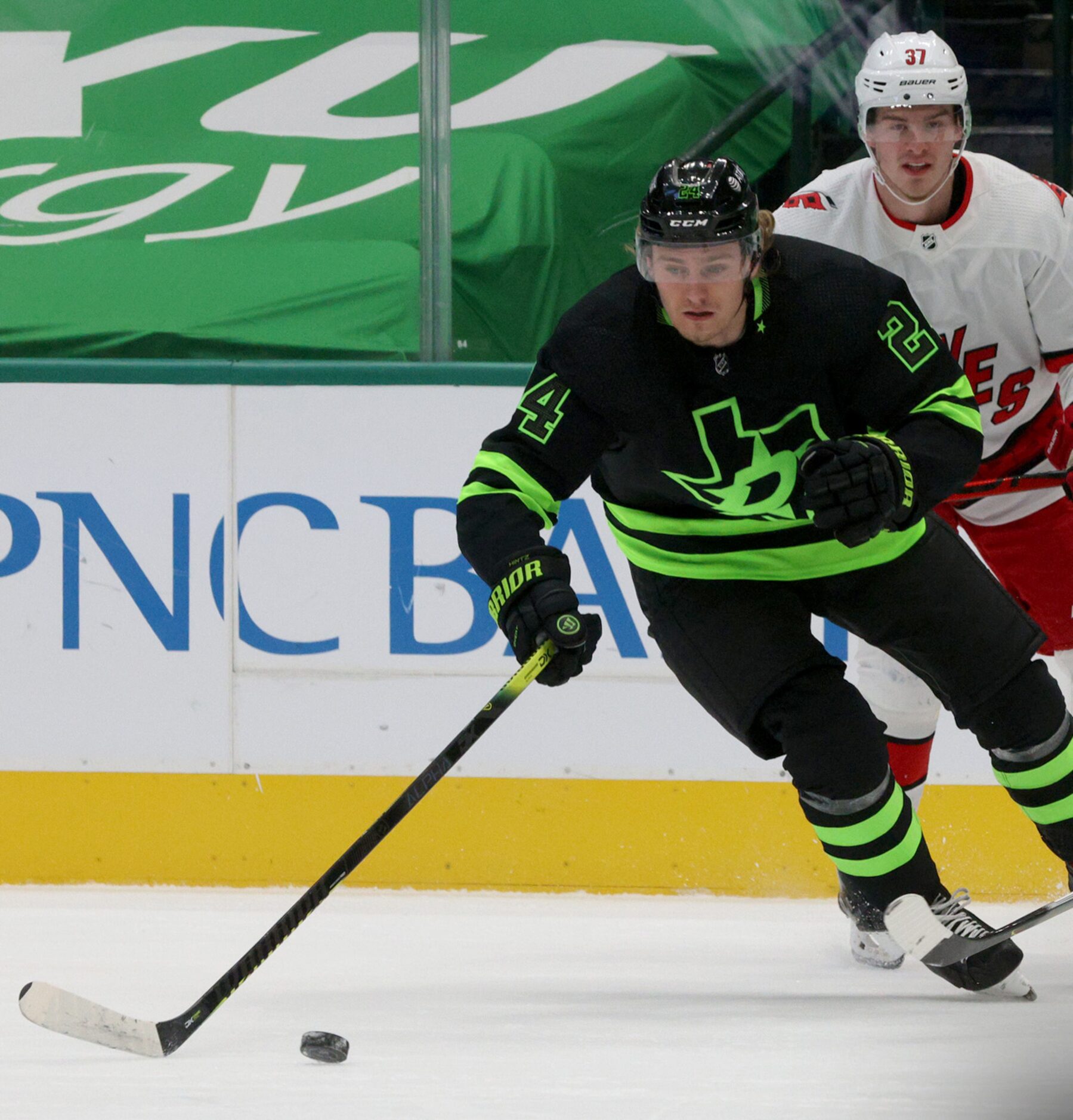 Dallas Stars left wing Roope Hintz (24) moves the puck away from Hurricanes defense during...