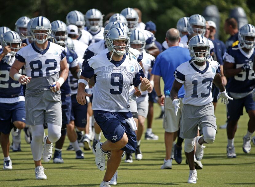 Dallas Cowboys quarterback Tony Romo (9) leads the team during a warm-up at the team's last...