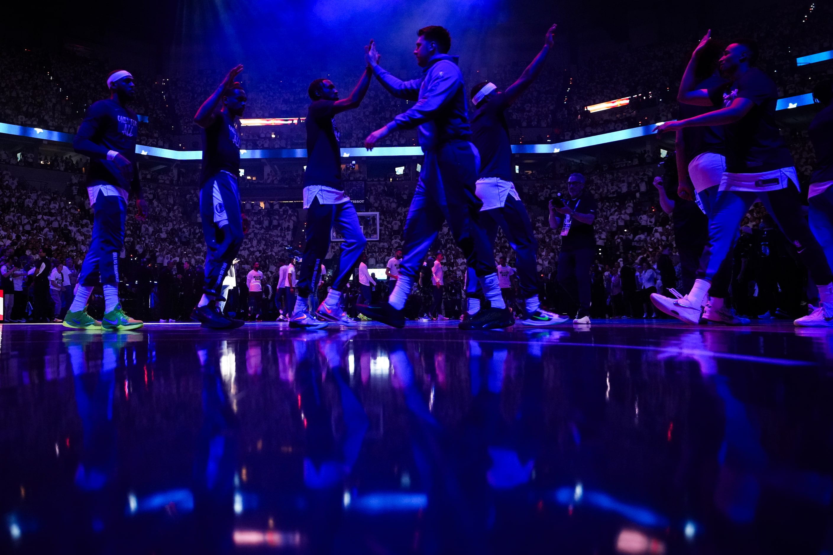 Dallas Mavericks guard Luka Doncic high fives teammates before Game 5 of the NBA basketball...