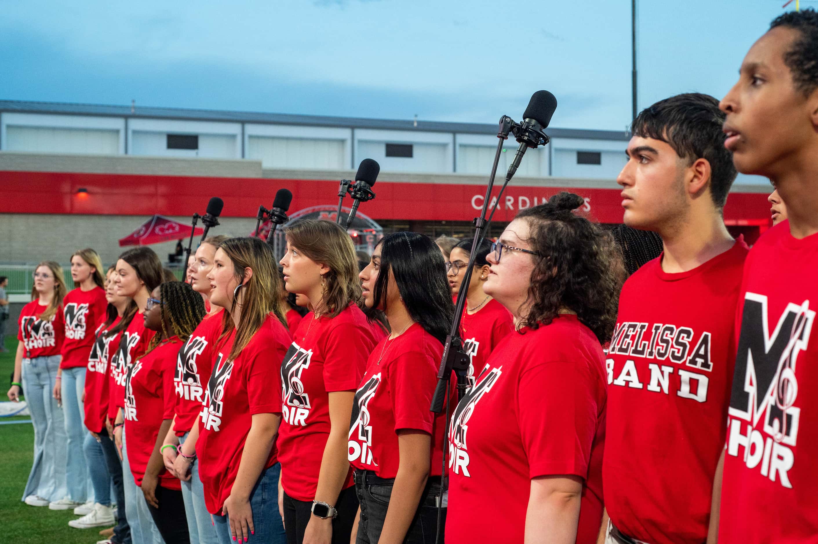 The Melissa choir perform the National Anthem before a high school football game between...