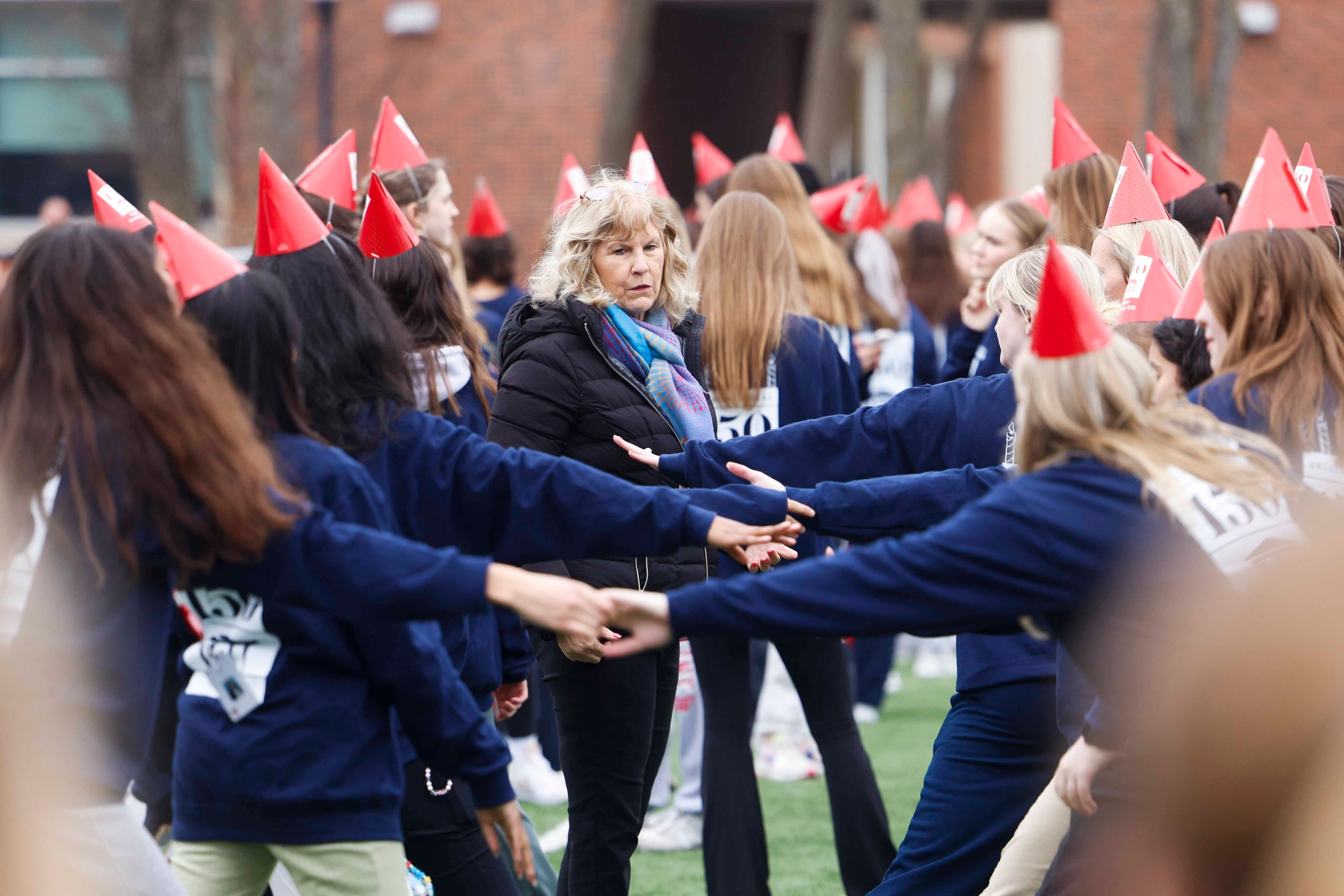 Judy Nordseth (center) coordinates the students for a formation of "UA 150" for a giant...