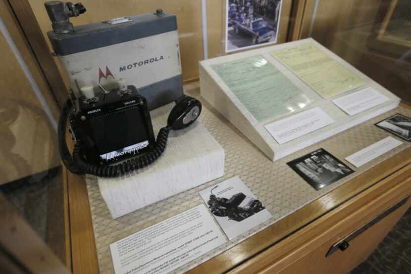 A Motorola motorcycle police radio transmitter, with a speaker and microphone, is on display...
