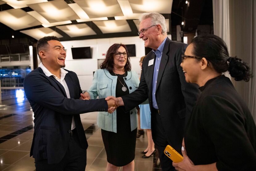 Agent Fernando Aguilera (left) shakes hands with Jim Fite, president and chief executive...