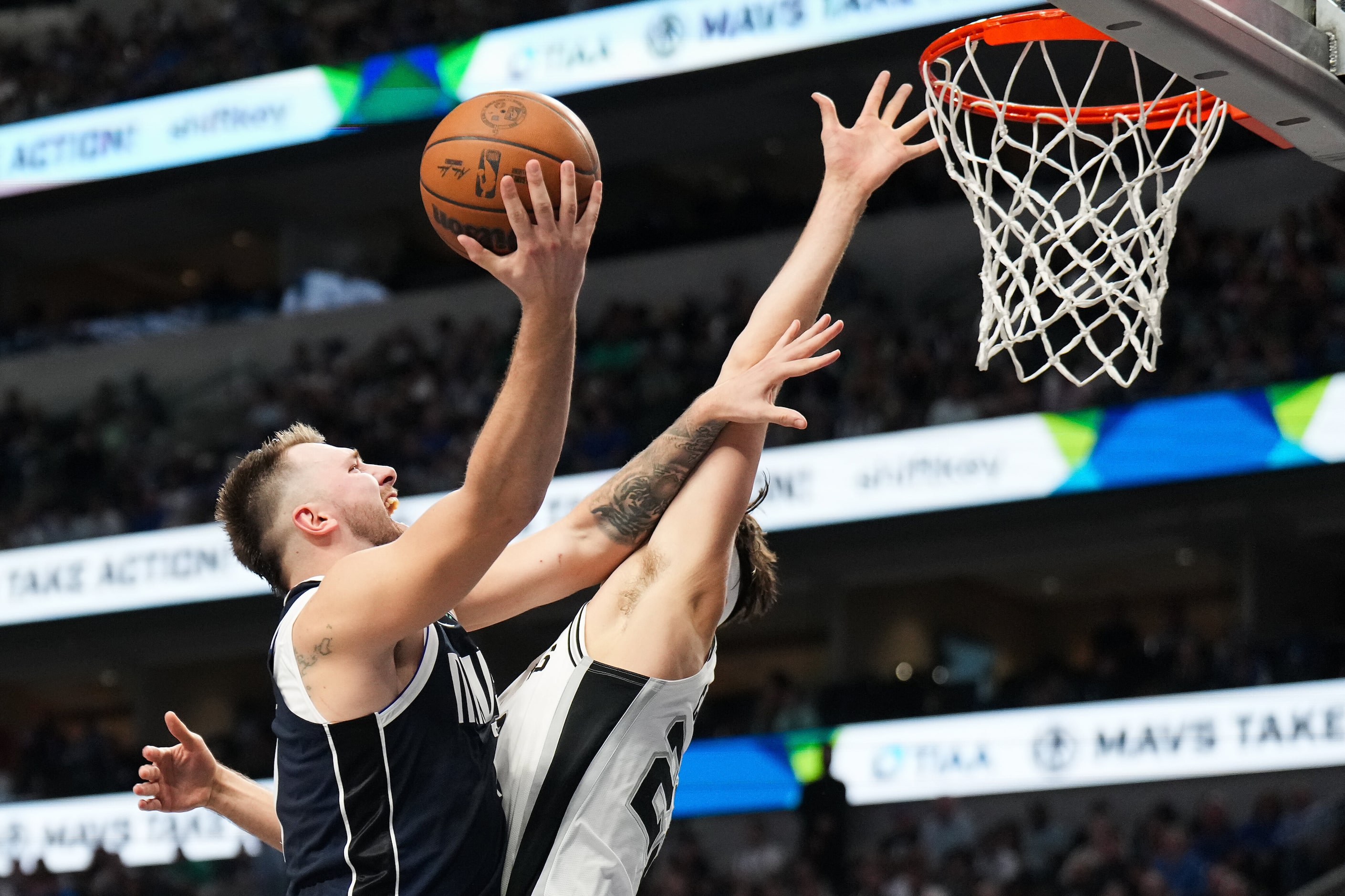 Dallas Mavericks guard Luka Doncic (77) drives against San Antonio Spurs forward Zach...