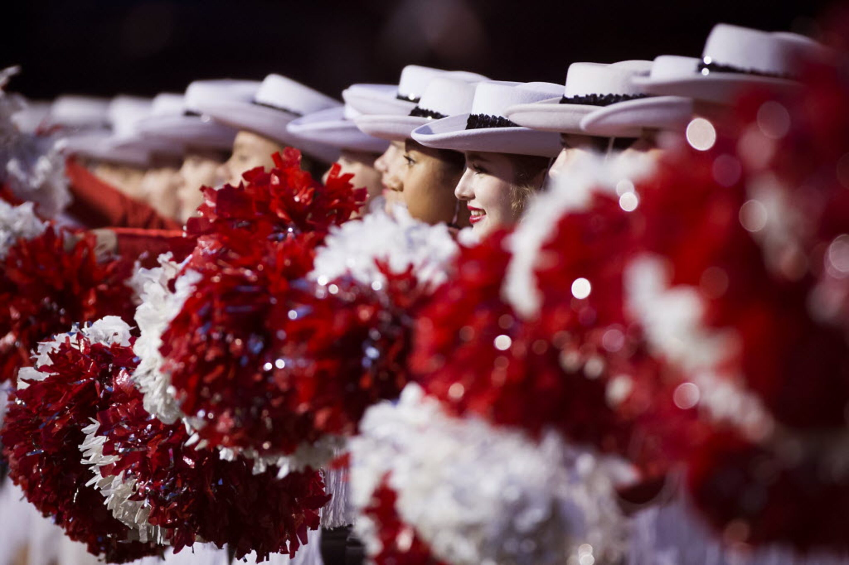 Coppell drill team members stand for their school song  before a high school football game...