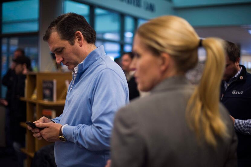  Republican Presidential Candidate Ted Cruz checks his phone backstage prior to speaking at...