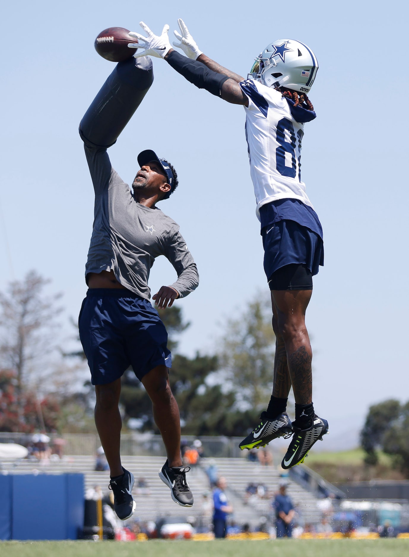 Dallas Cowboys wide receiver CeeDee Lamb (88)  goes high over wide receivers coach Robert...