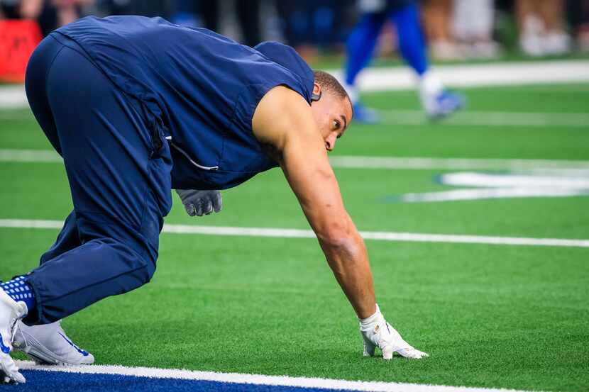 FILE - Cowboys defensive lineman Tyrone Crawford warms up before a game against the Green...