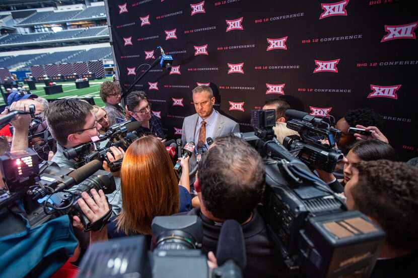 University of Texas head football coach Tom Herman speaks with reporters during the Big 12...