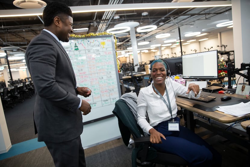 Chime Solutions vice president Omar Hawk, left, chats with employee Tia Haywood. He spends a...