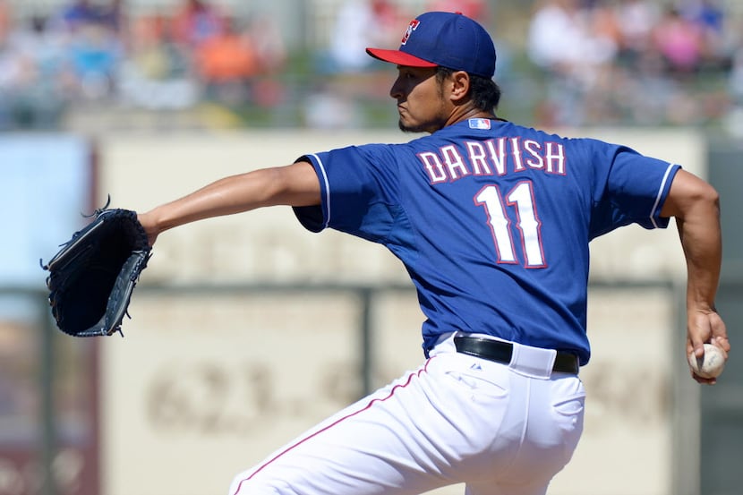 Mar 11, 2013; Surprise, AZ, USA; Texas Rangers starting pitcher Yu Darvish (11) pitches...