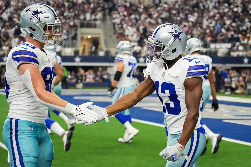 Dallas Cowboys wide receiver Michael Gallup (13) celebrates a touchdown catch with tight end...