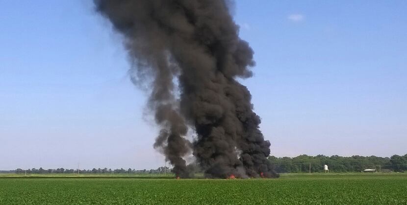 Smoke and flames come from the wreckage after a military transport airplane crashed in a...