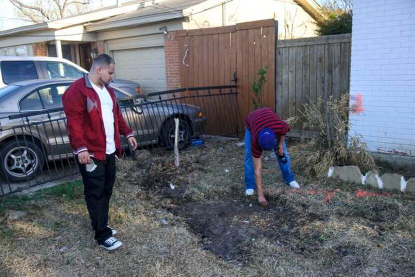 
Eric Sorto (left) and Juan-Carlos Carein picked up debris Sunday from a crash Saturday in...
