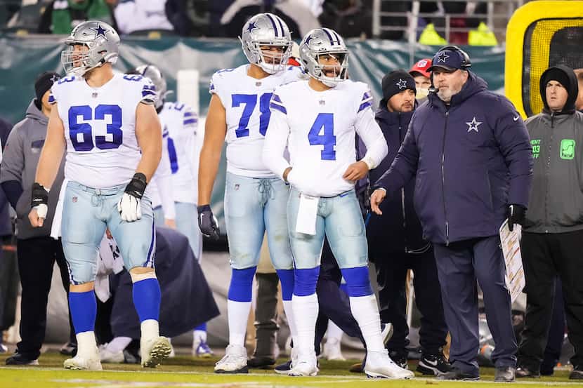 Dallas Cowboys quarterback Dak Prescott (4) waits to come into the game with head coach Mike...