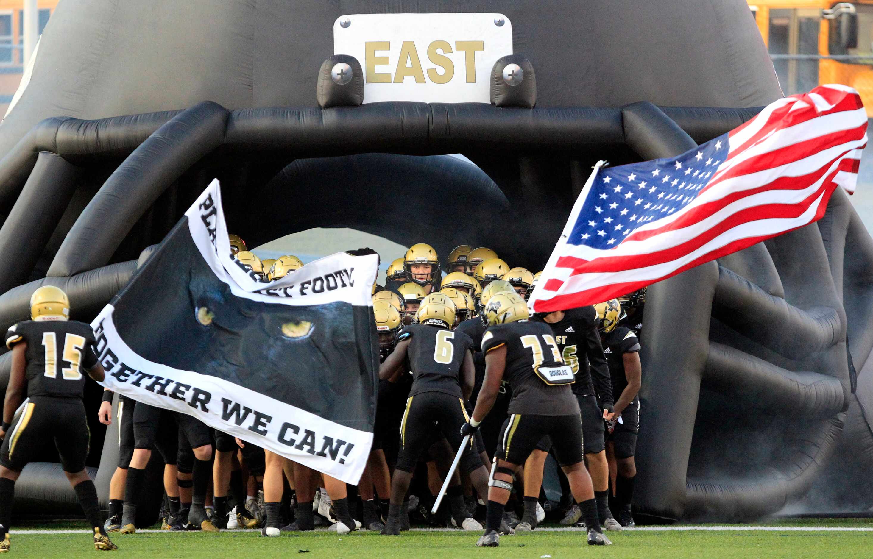 The Plano East team prepares to enter the field before the first half of a high school...