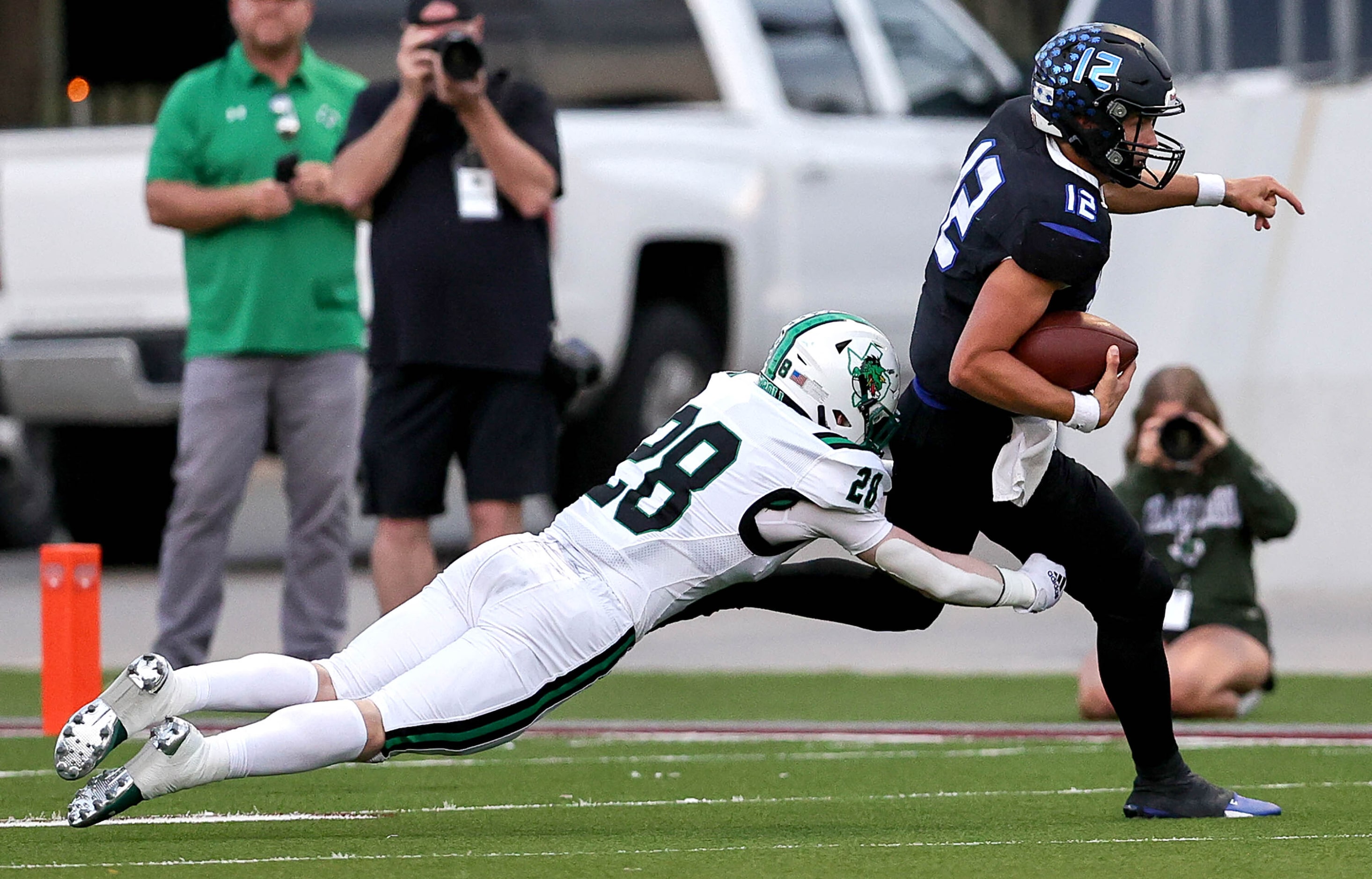 Byron Nelson quarterback Tom Von Grote (12) tries scrambles past Southlake Carroll...