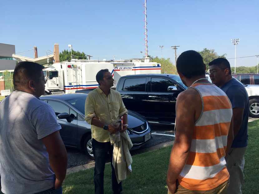 Mexican Consulate employee Ruben Ovando speaks with Mexican carpenters who are among the...