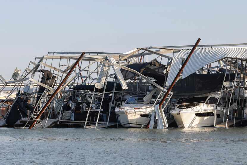 Docks and boats are damaged at Lake Lewisville marina Friday, after a severe storm moved...
