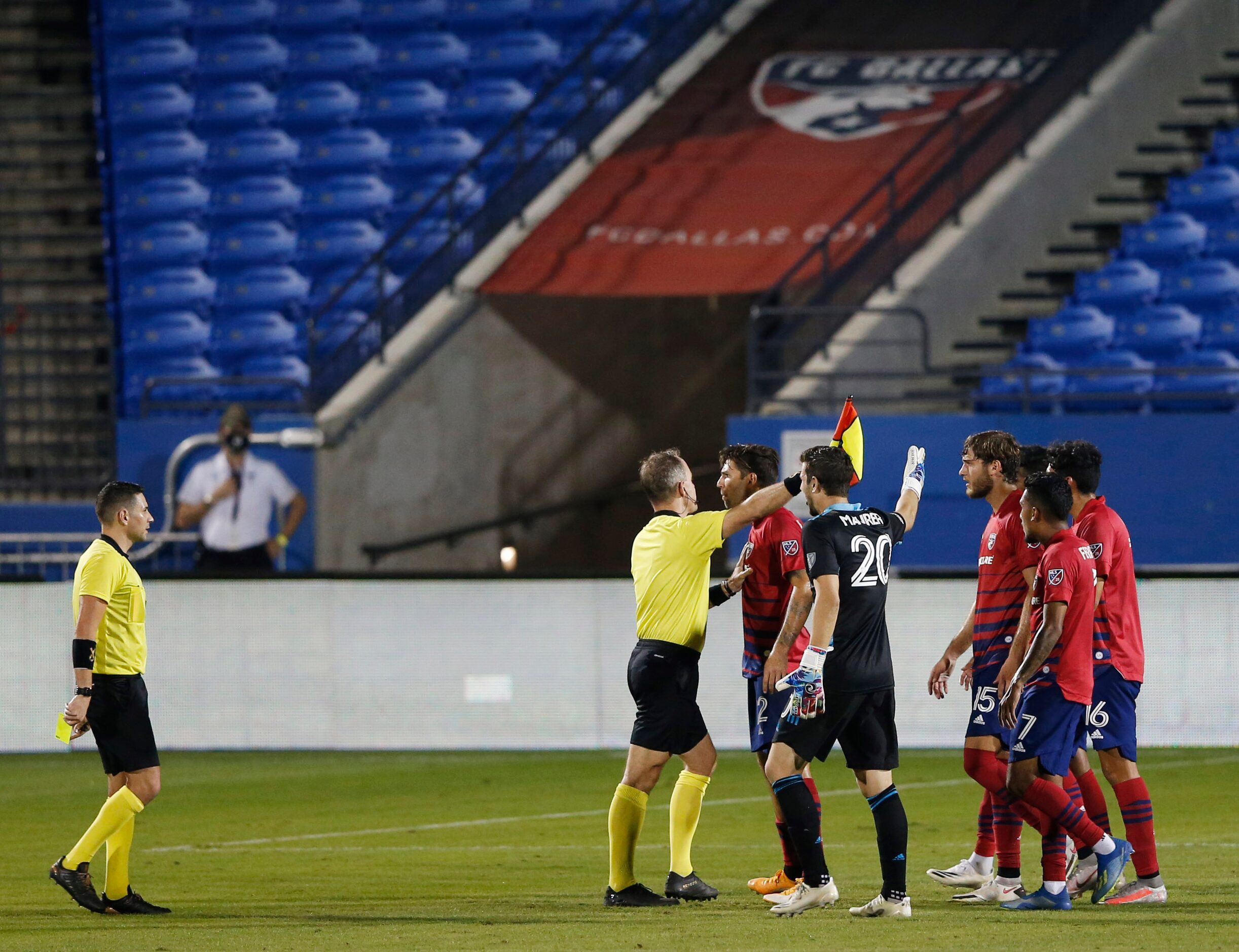 FC Dallas players argue the calling of the end of the game with referees after the end of...