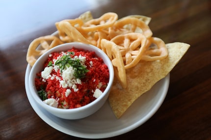 Chef Brian Luscher calls Suburban Yacht Club's Flamin’ Hot Cheetos Elote one of several...