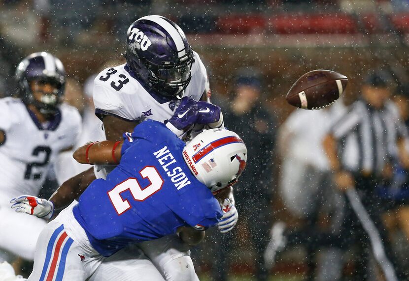 TCU running back Sewo Olonilua (33) fumbles the ball after a hit by SMU safety Patrick...