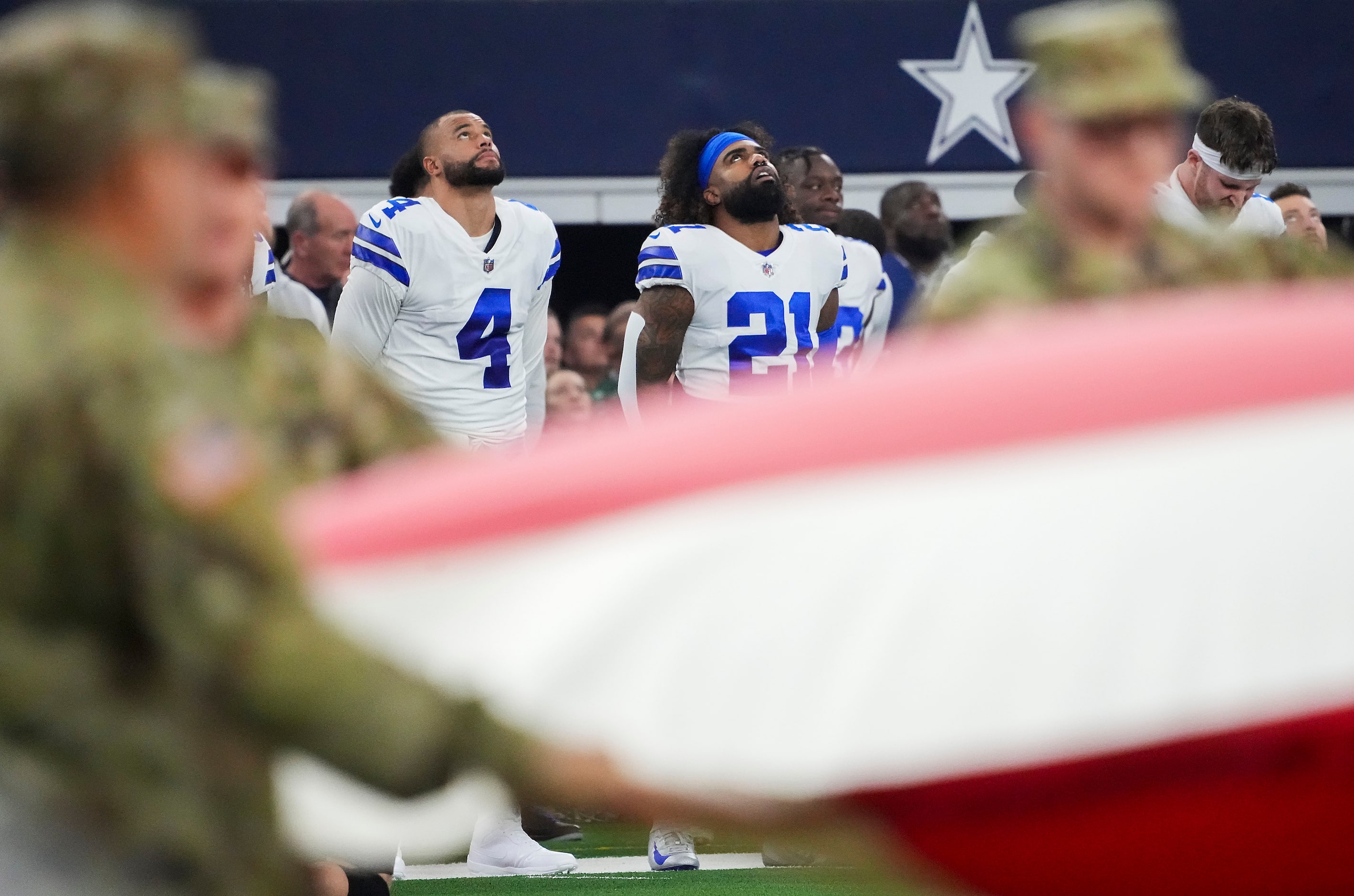 Dallas Cowboys quarterback Dak Prescott (4) and running back Ezekiel Elliott (21) stand for...