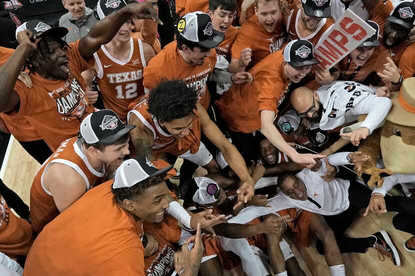 Interim Texas head coach Rodney Terry, bottom right, celebrates with his team after Texas...